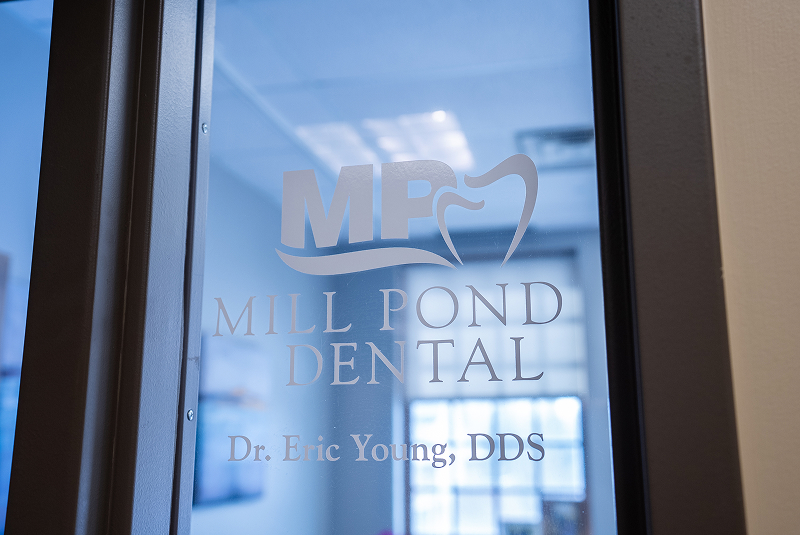 Frosted glass door with Mill Pond Dental logo