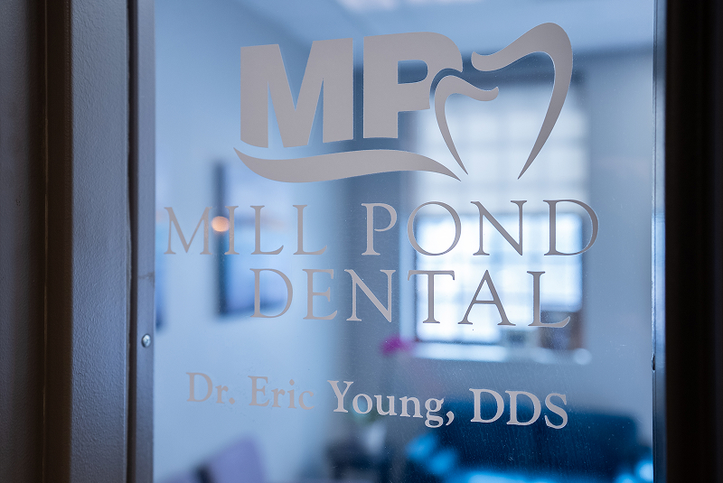Mill Pond Dental logo on frosted office door