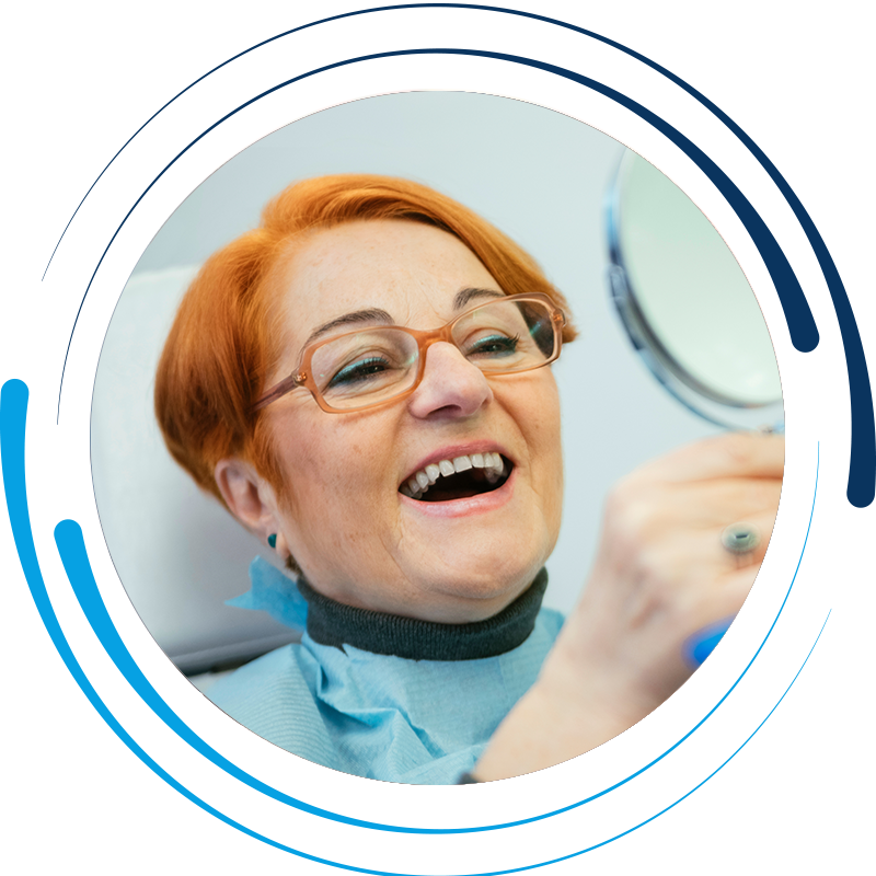 woman-with-dentures-looking-into-mirror